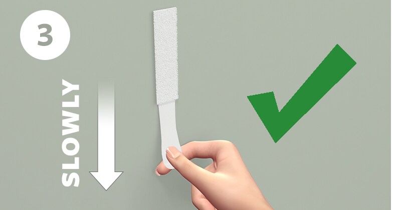 移除無痕™ 膠條 Step 3: 平行牆面將膠條緩慢下拉，即可移除。

